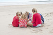 Kids sitting in circle on beach
