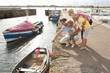 Family looking at boat in harbor