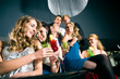 People in club or bar drinking cocktails