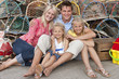 Photo: Portrait of smiling family leaning against lobster traps Portrait of smiling family leaning against lobster traps