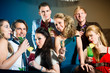 People in club or bar drinking cocktails