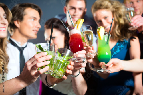 Photo: People in club or bar drinking cocktails People in club or bar drinking cocktails