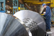 Engineers working on metal machinery