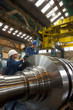 Engineers working on metal machinery