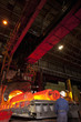 Engineer watching molten forged steel in furnace