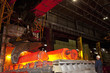 Engineer watching molten forged steel in furnace