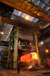 Engineer watching molten forged steel in furnace