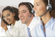 Smiling business people wearing headsets