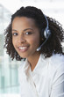 Close up portrait of smiling businesswoman wearing headset