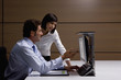 Businessman and businesswoman working at computer in office