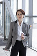 Photo : Businesswoman with passport arriving at airport Businesswoman with passport arriving at airport