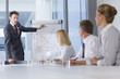 Photo: Businessman presenting graph to co-workers in meeting Businessman presenting graph to co-workers in meeting