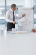 Photo: Businessman writing on chart in conference room Businessman writing on chart in conference room