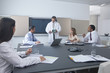 Engineer showing business people electronics part in conference room
