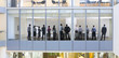 View of business people standing in conference room from outdoors