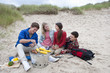Teenage couples enjoying barbecue on beach