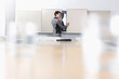 Businesswoman opening cabinet in conference room