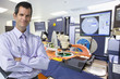Portrait of smiling businessman in silicon wafer manufacturing laboratory