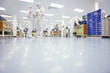 Photo: Scientists in clean suits talking in silicon wafer manufacturing laboratory Scientists in clean suits talking in silicon wafer manufacturing laboratory