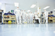 Photo: Portrait of engineers in clean suits in silicon wafer manufacturing laboratory Portrait of engineers in clean suits in silicon wafer manufacturing laboratory