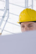 Close up of architect in hard-hat reviewing blueprints