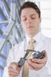 Close up of engineer measuring machine part with calipers