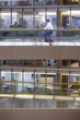 Businessman riding bicycle down office corridor