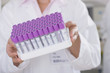 Photo: Technician holding vials in laboratory Technician holding vials in laboratory