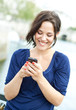 Young woman writing on a phone