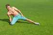 Young man training on green grass
