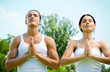 Young couple meditating, outdoor