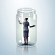 Businesswoman inside glass jar