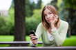Thoughtful Woman holding Cell Phone