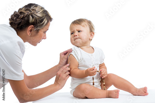 Photo: doctor vaccinating baby isolated on a white background doctor vaccinating baby isolated on a white background