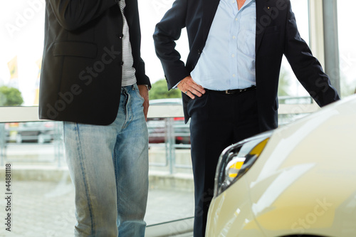 Photo: Man buying car from salesperson Man buying car from salesperson