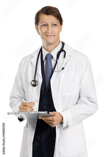 Photo: Handsome doctor writing on medical chart Handsome doctor writing on medical chart