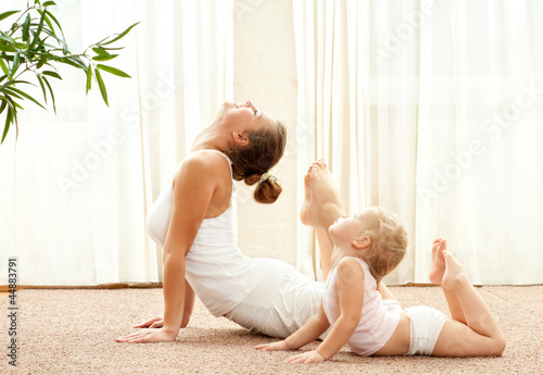Photo: Mother and daughter doind exercise Mother and daughter doind exercise