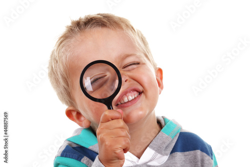 Photo: Boy searching with magnifying glass Boy searching with magnifying glass