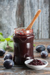 Homemade plum jam on wooden table