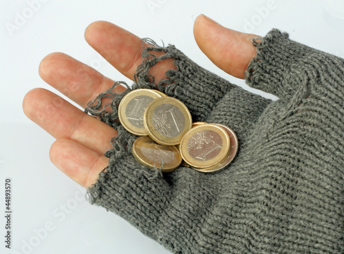 Photo: poor man collects alms from a few Euros in his glove poor man collects alms from a few Euros in his glove