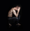 Photo: Muscular man in sitting pose Muscular man in sitting pose