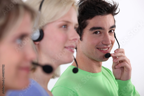 Photo: Three young call-center workers Three young call-center workers