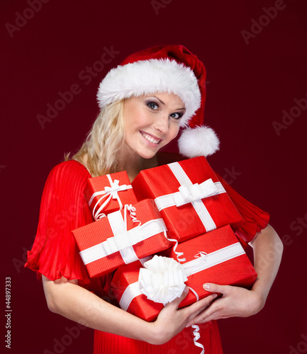 Photo: Beautiful lady in Christmas cap hands Beautiful lady in Christmas cap hands
