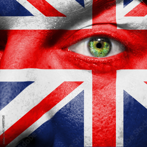 Photo: Flag painted on face with green eye to show UK support Flag painted on face with green eye to show UK support