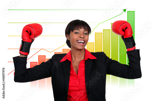 Photo: Businesswoman wearing boxing gloves Businesswoman wearing boxing gloves