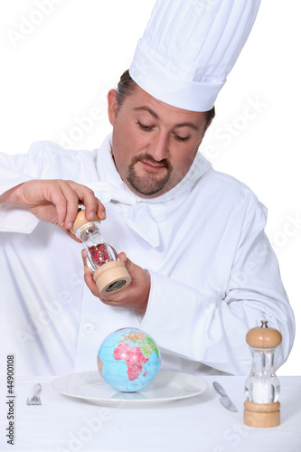 Photo: a cook seasoning a globe a cook seasoning a globe