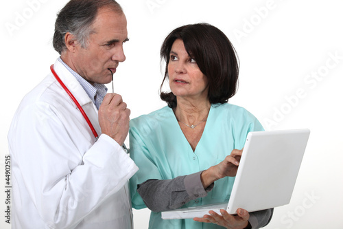 Photo: Two hospital workers with laptop Two hospital workers with laptop
