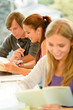 Teens study in high-school library reading student