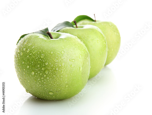 Photo: Ripe green apples with leaves isolated on white Ripe green apples with leaves isolated on white