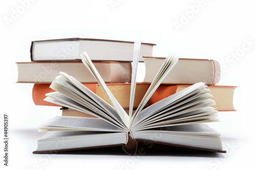 Photo: A stack of books on a white background. A stack of books on a white background.